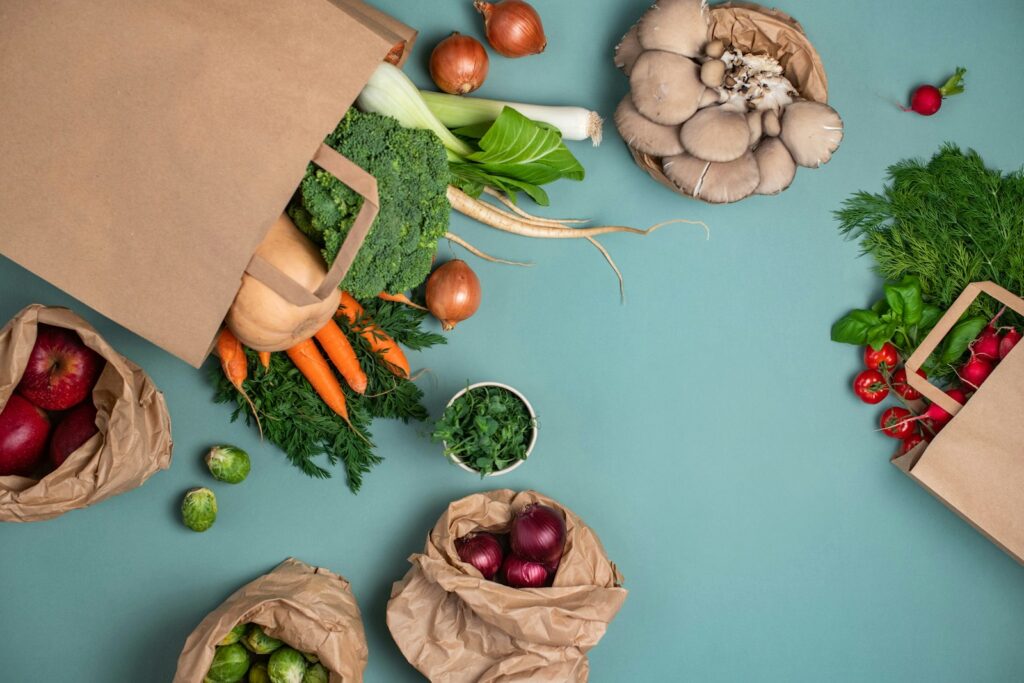 Paper grocery bags of fresh vegetables