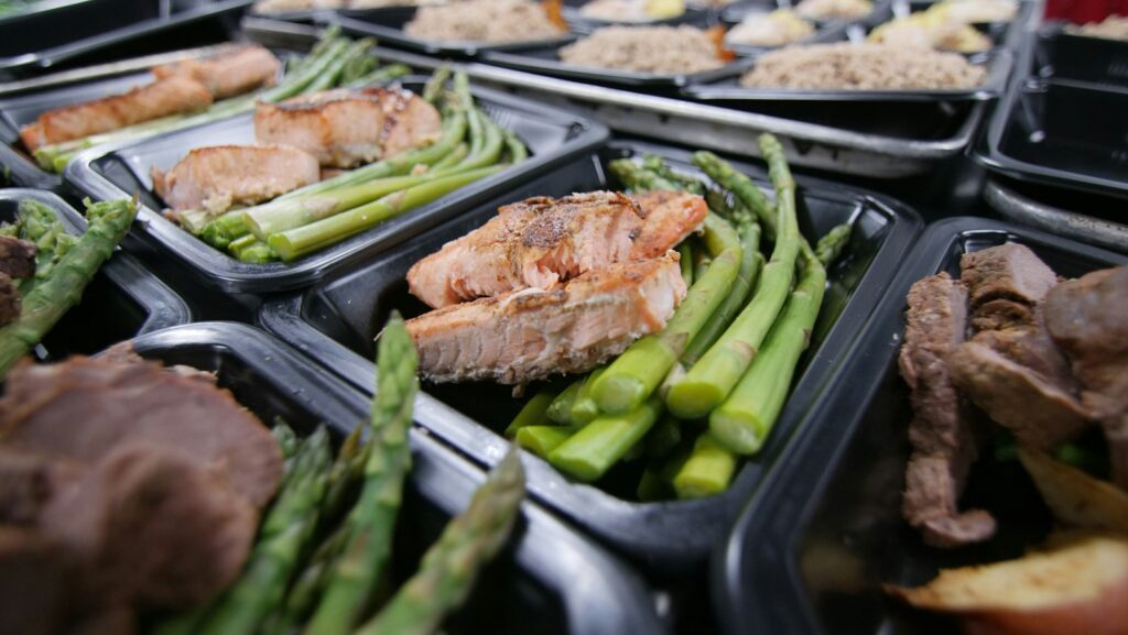 Meal prep trays of salmon and asparagus