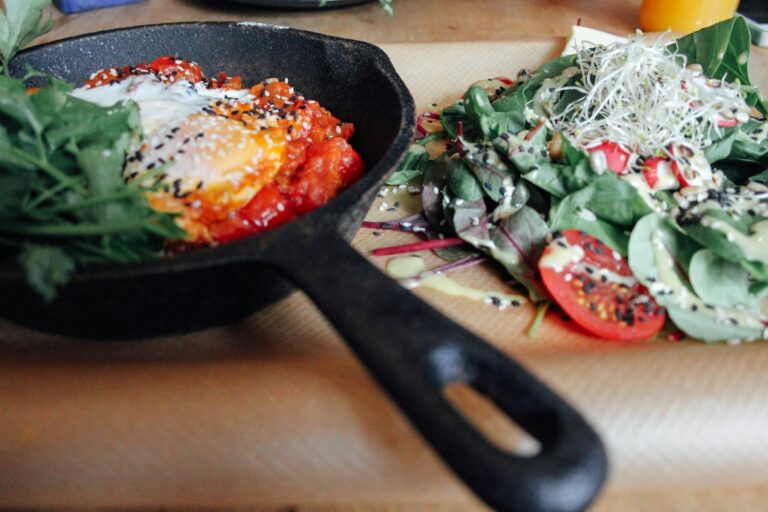 Eggs in a cast-iron skillet with a green salad